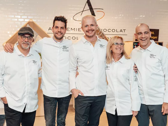 A judge tastes a competitor's dessert in the 2022 competition